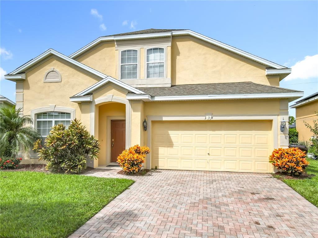 334 Cadiz Loop Davenport, FL 33837 - Photo 7 of 63 a front view of a house with a yard and garage
