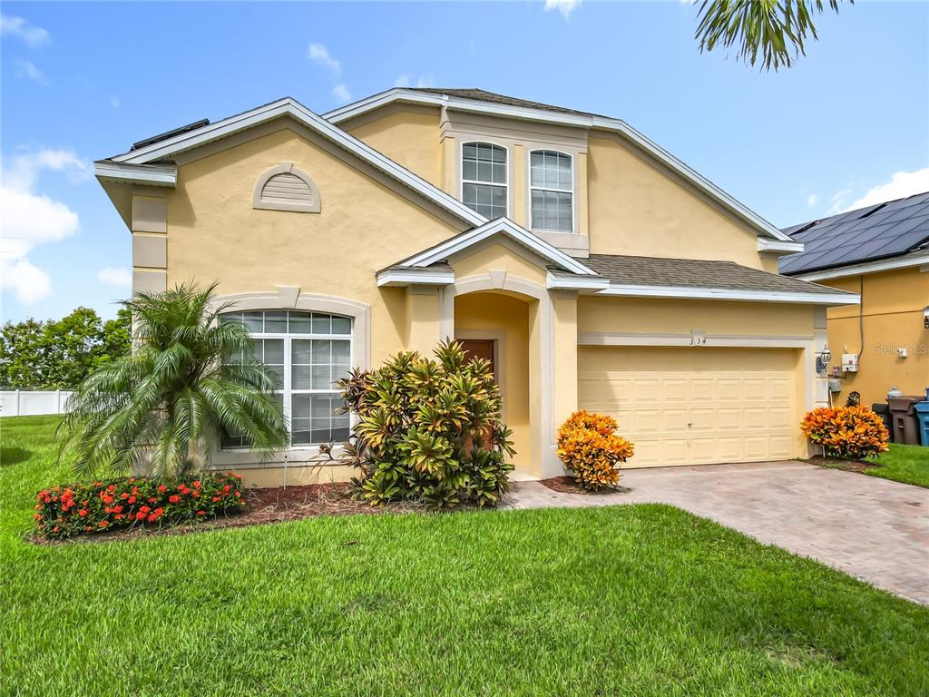 334 Cadiz Loop Davenport, FL 33837 - Photo 8 of 63 a front view of a house with a yard and garage