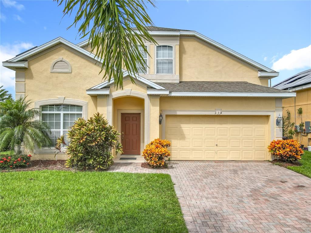 334 Cadiz Loop Davenport, FL 33837 - Photo 10 of 63 a front view of a house with a yard and garage
