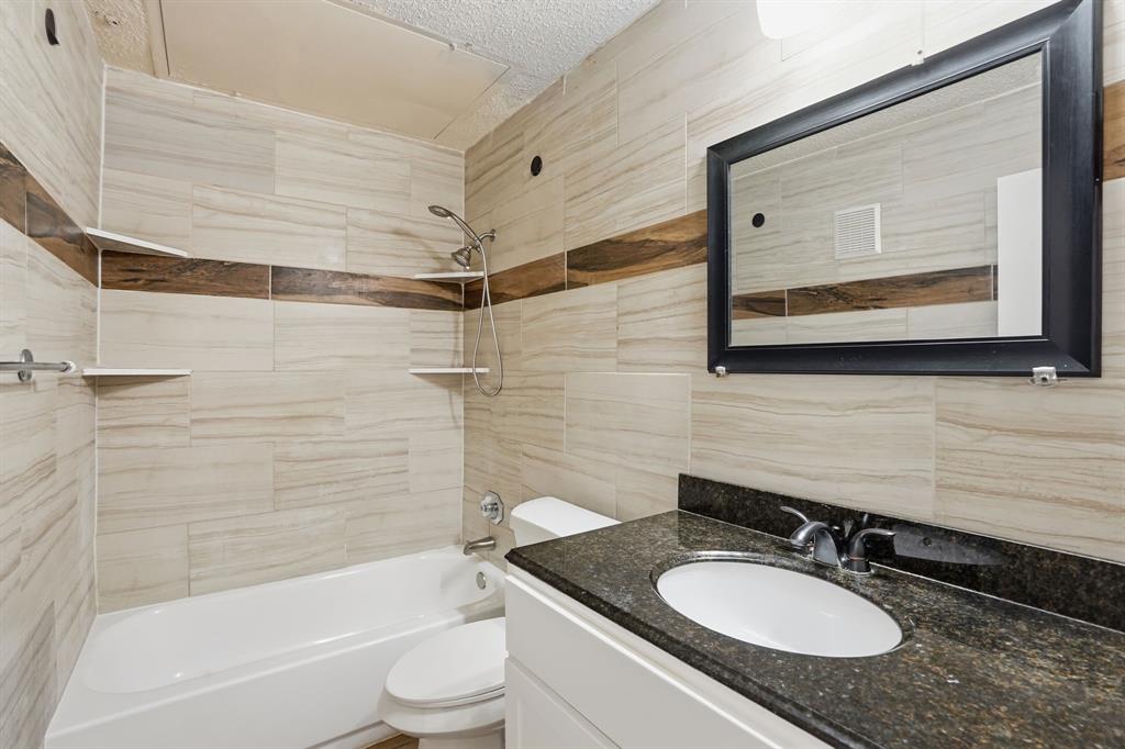 4101 Esters Road, Unit 101 Irving, TX 75038 - Photo 13 of 24 Renovated bathroom with stylish tile & fixtures
