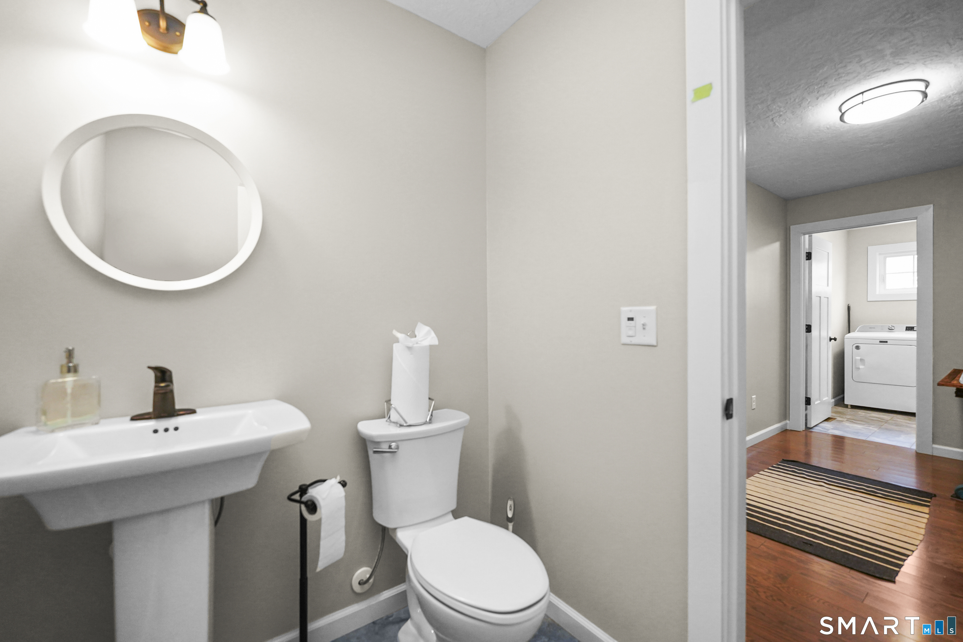 42 Chapman Chase, Unit 42 Windsor Locks, CT 06096 - Photo 16 of 38 a bathroom with a toilet a sink and mirror