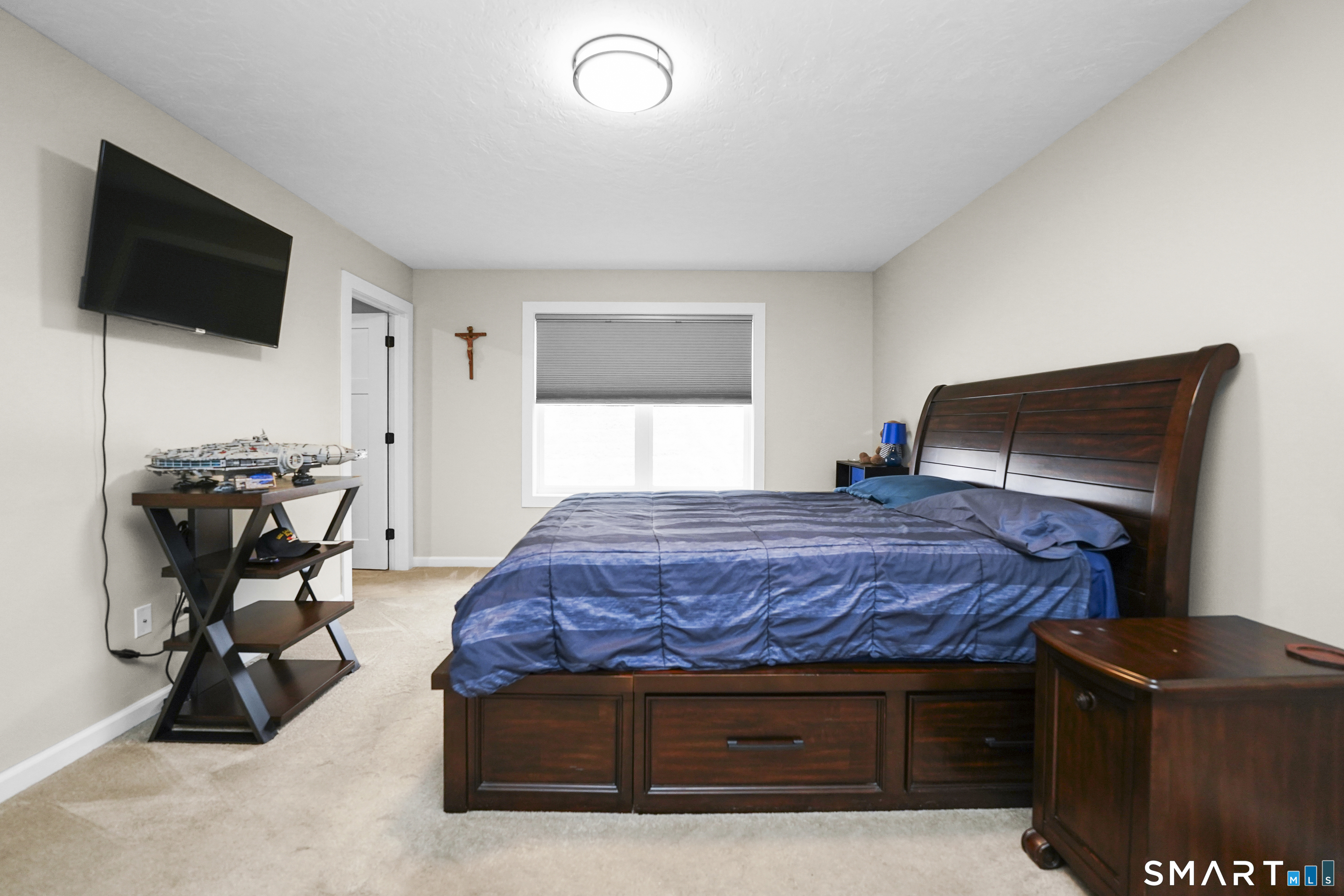 42 Chapman Chase, Unit 42 Windsor Locks, CT 06096 - Photo 23 of 38 a bedroom with furniture and a flat screen tv