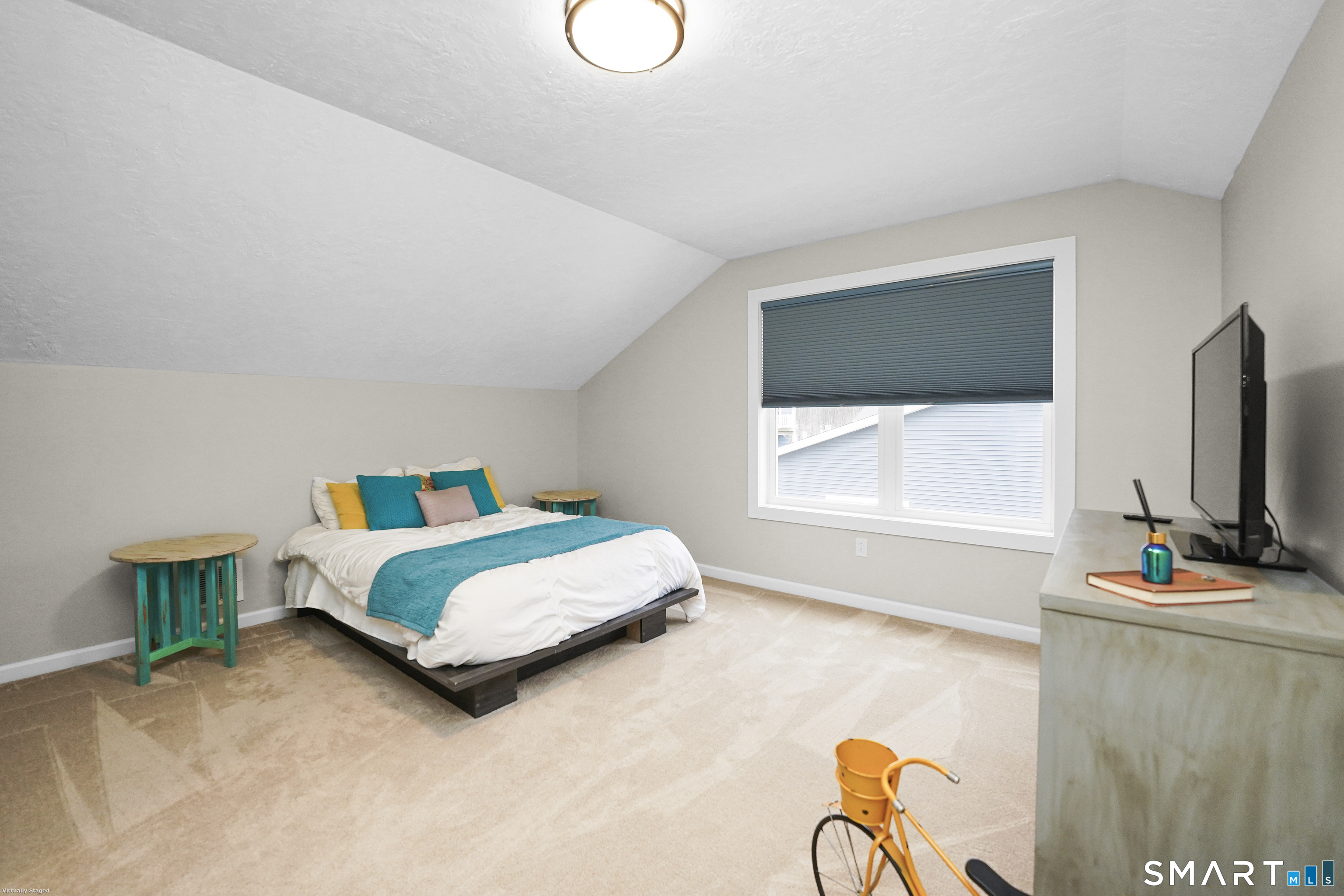 42 Chapman Chase, Unit 42 Windsor Locks, CT 06096 - Photo 29 of 38 a living room with a bed furniture and a flat screen tv