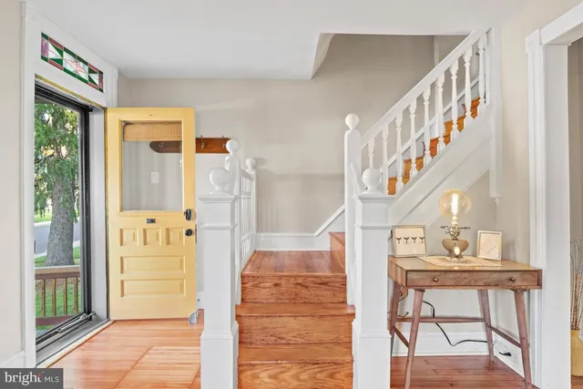a view of entryway livingroom and hall with wooden floor