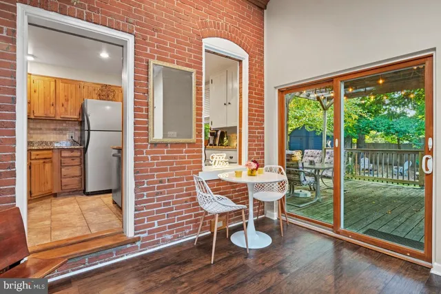 a view of a porch with a table and chairs