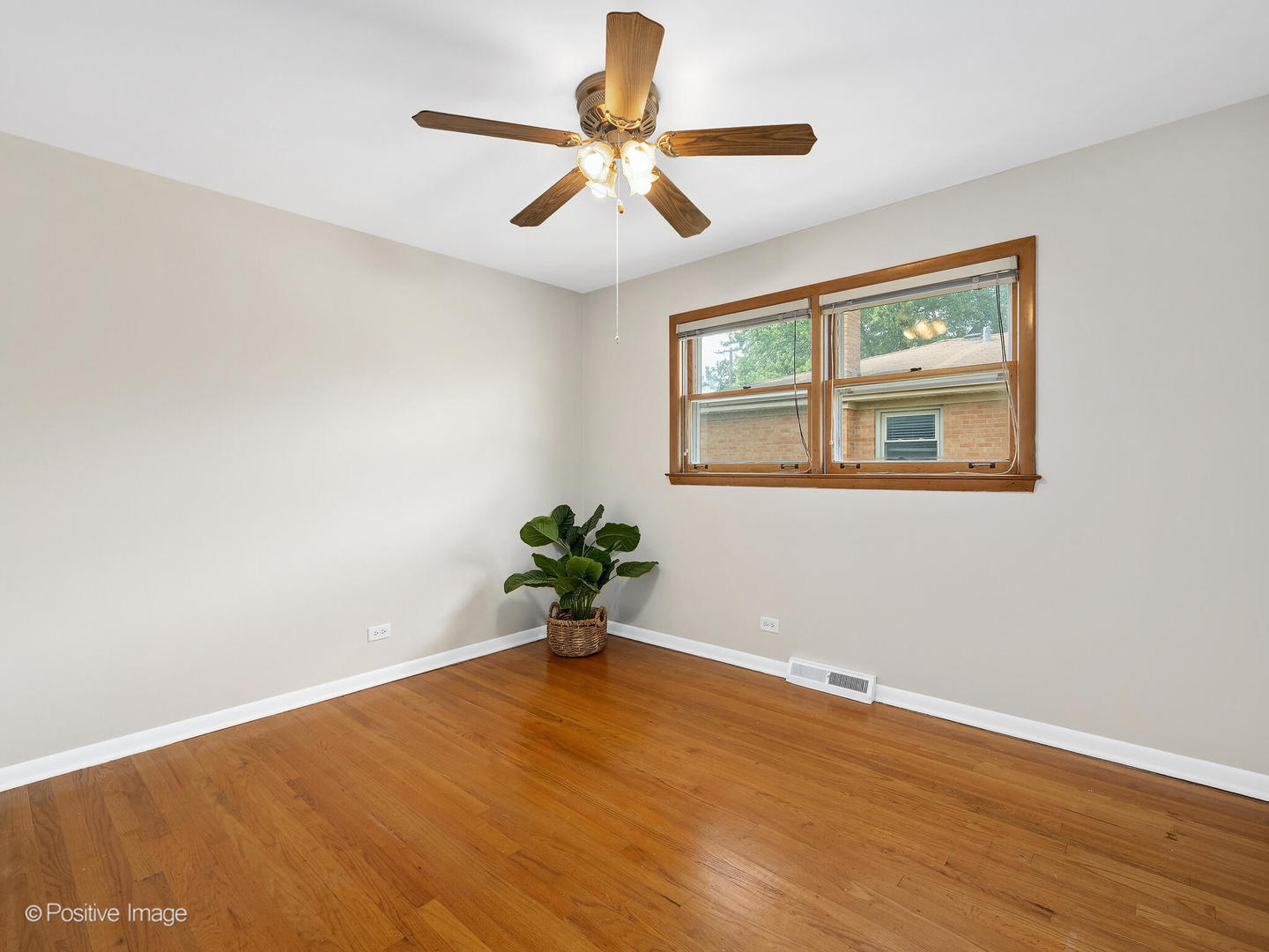 4220 Maple Avenue Brookfield, IL 60513 - Photo 14 of 22 a view of an empty room with wooden floor and a ceiling fan