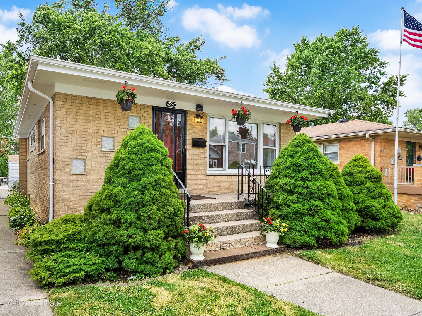 4220 Maple Avenue Brookfield, IL 60513 - Photo 2 of 22 a front view of a house with plants and garden