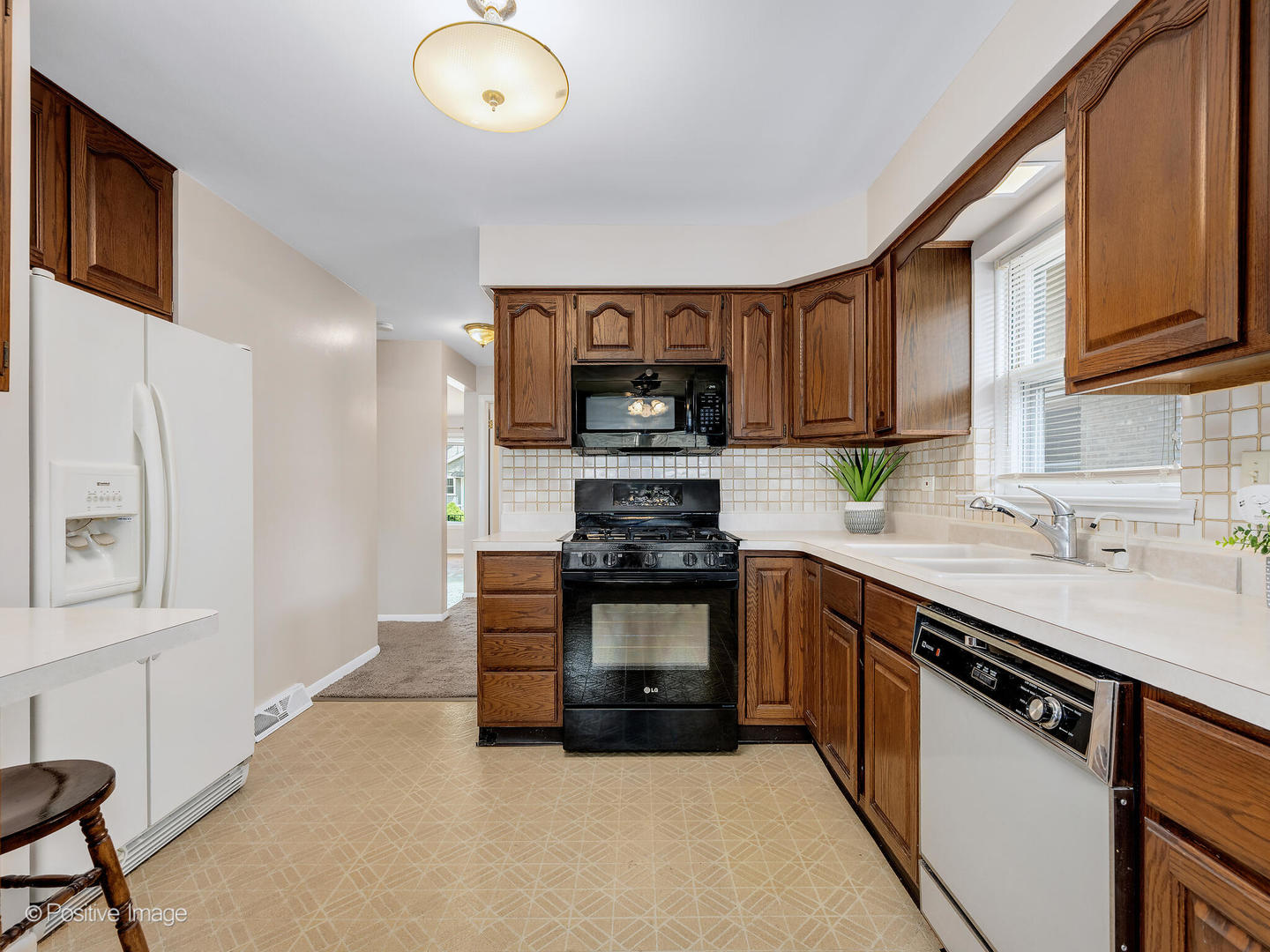 4220 Maple Avenue Brookfield, IL 60513 - Photo 8 of 22 a kitchen with stainless steel appliances granite countertop a stove sink and cabinets