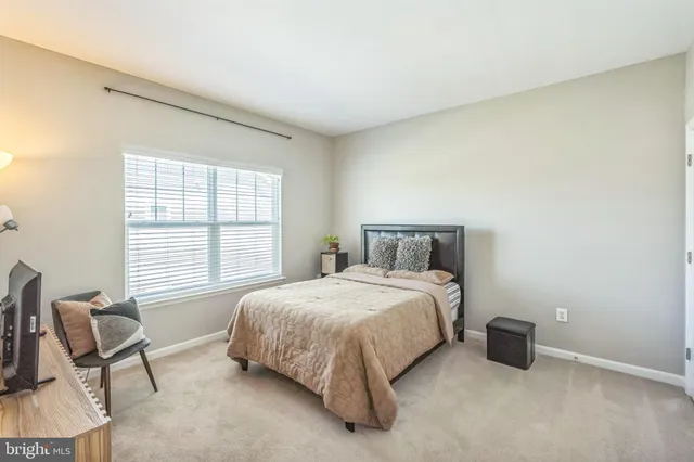 a bedroom with a bed and a chair