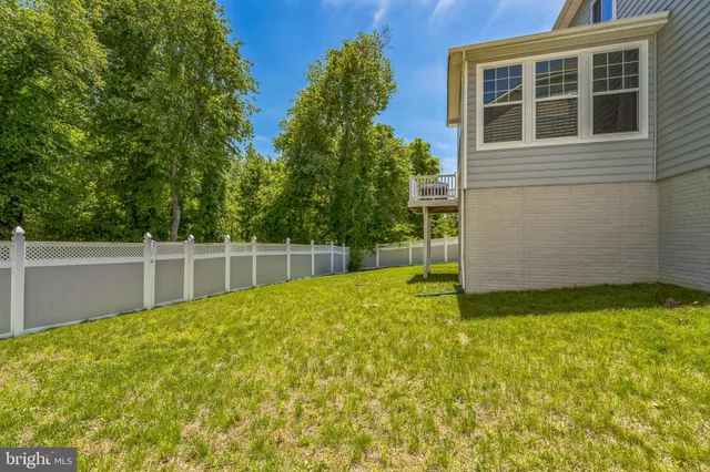 a view of house with backyard and a tub