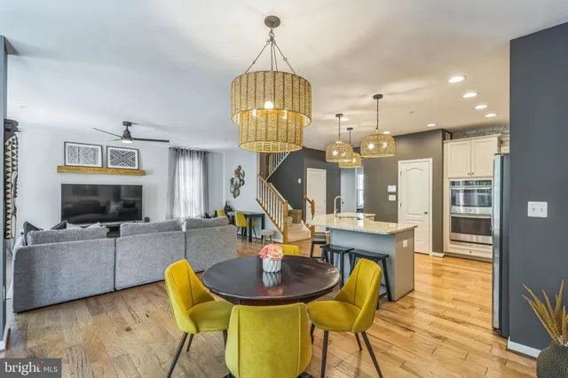 a view of a dining room with furniture a chandelier and wooden floor