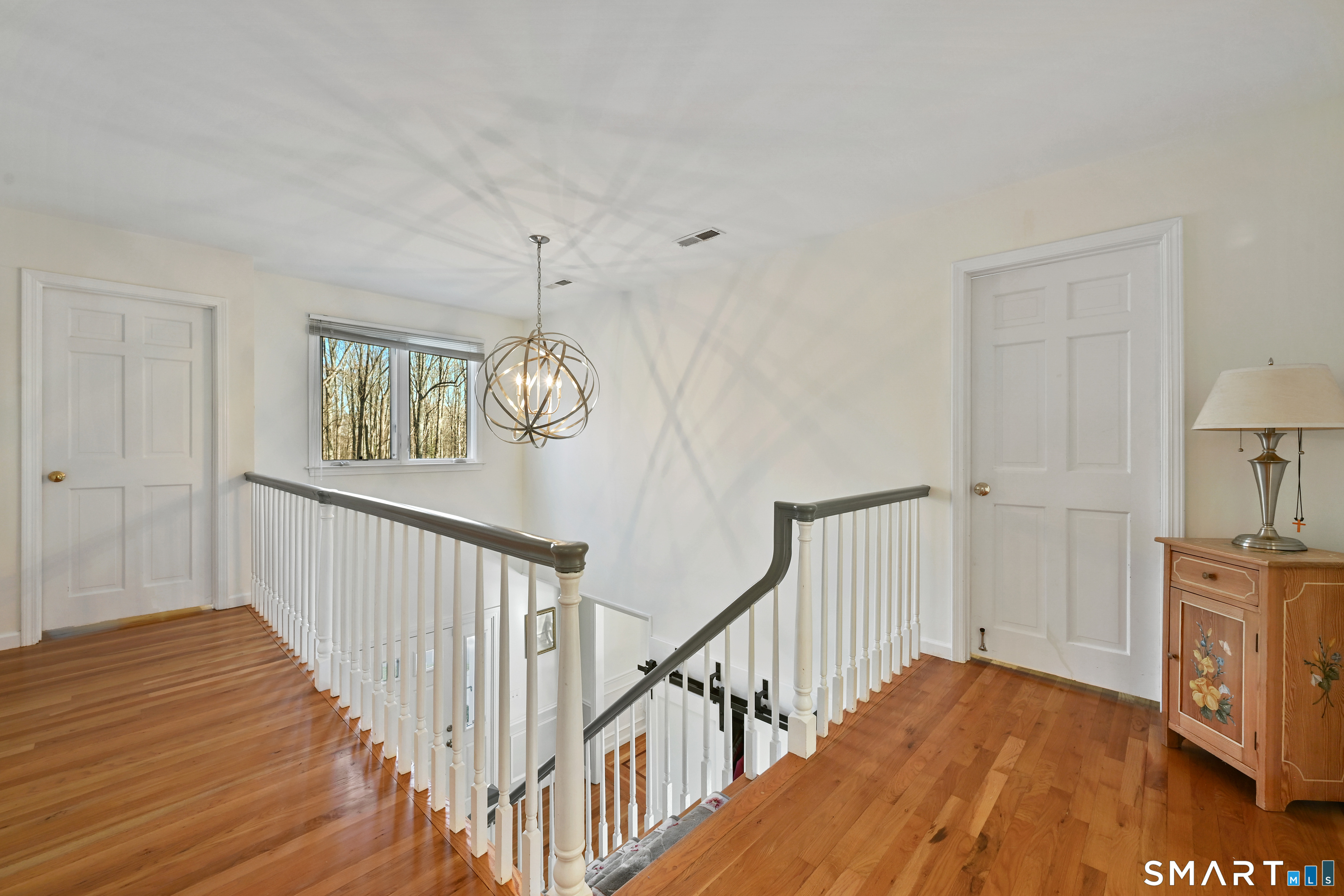 84 Delaware Road Easton, CT 06612 - Photo 17 of 39 a view of a hallway with wooden floor and staircase