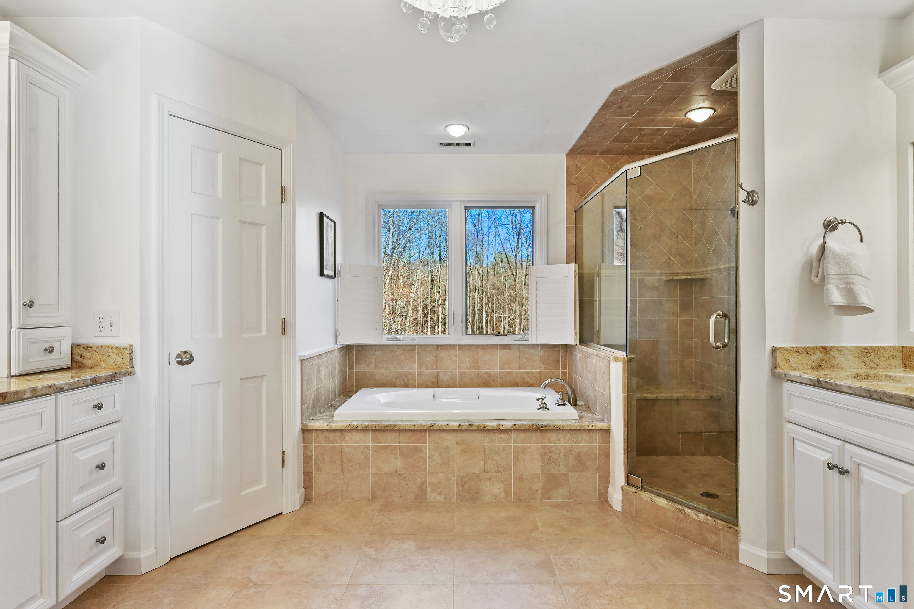 84 Delaware Road Easton, CT 06612 - Photo 19 of 39 a spacious bathroom with a granite countertop tub shower and mirror