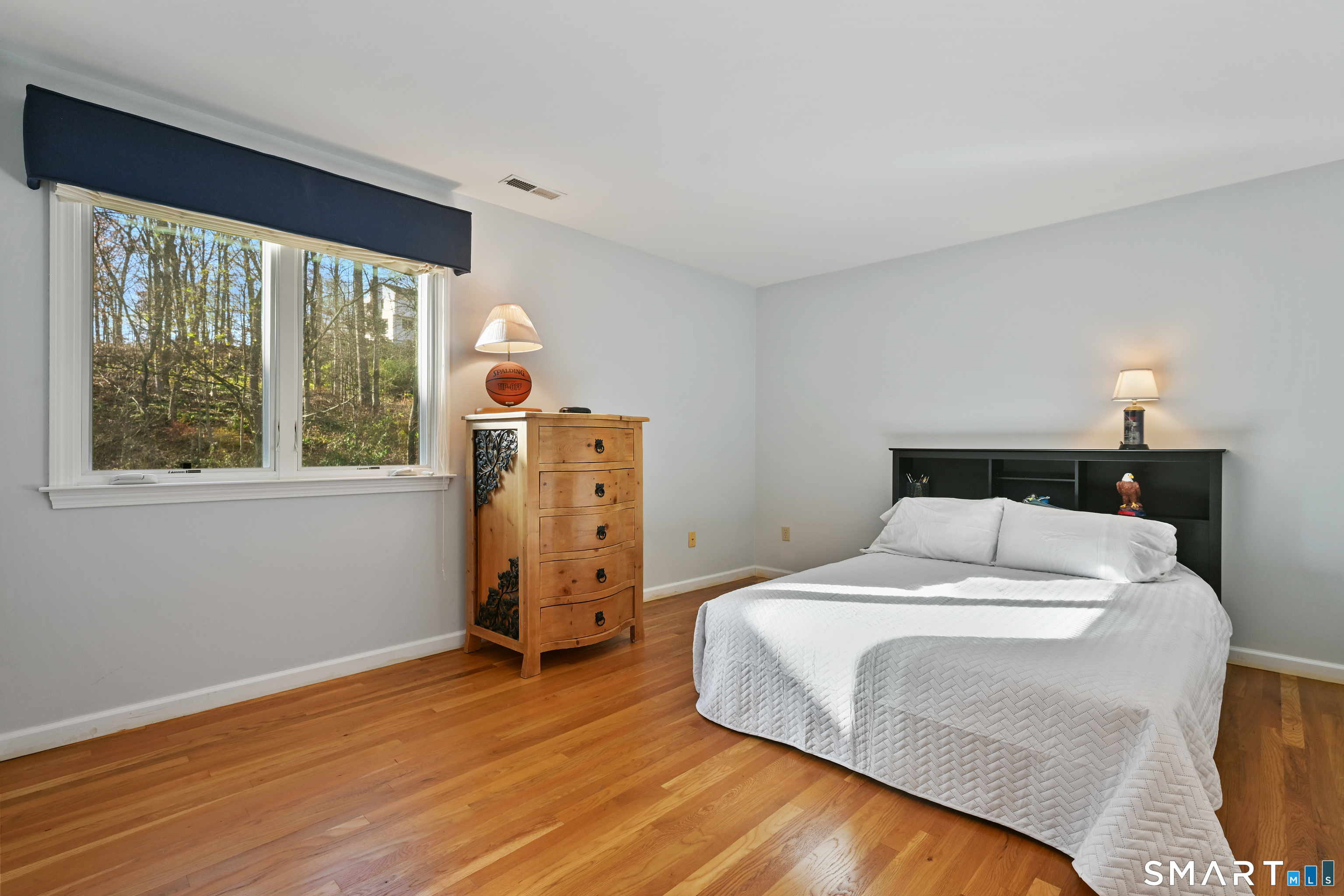 84 Delaware Road Easton, CT 06612 - Photo 22 of 39 a bedroom with a bed and wooden floor