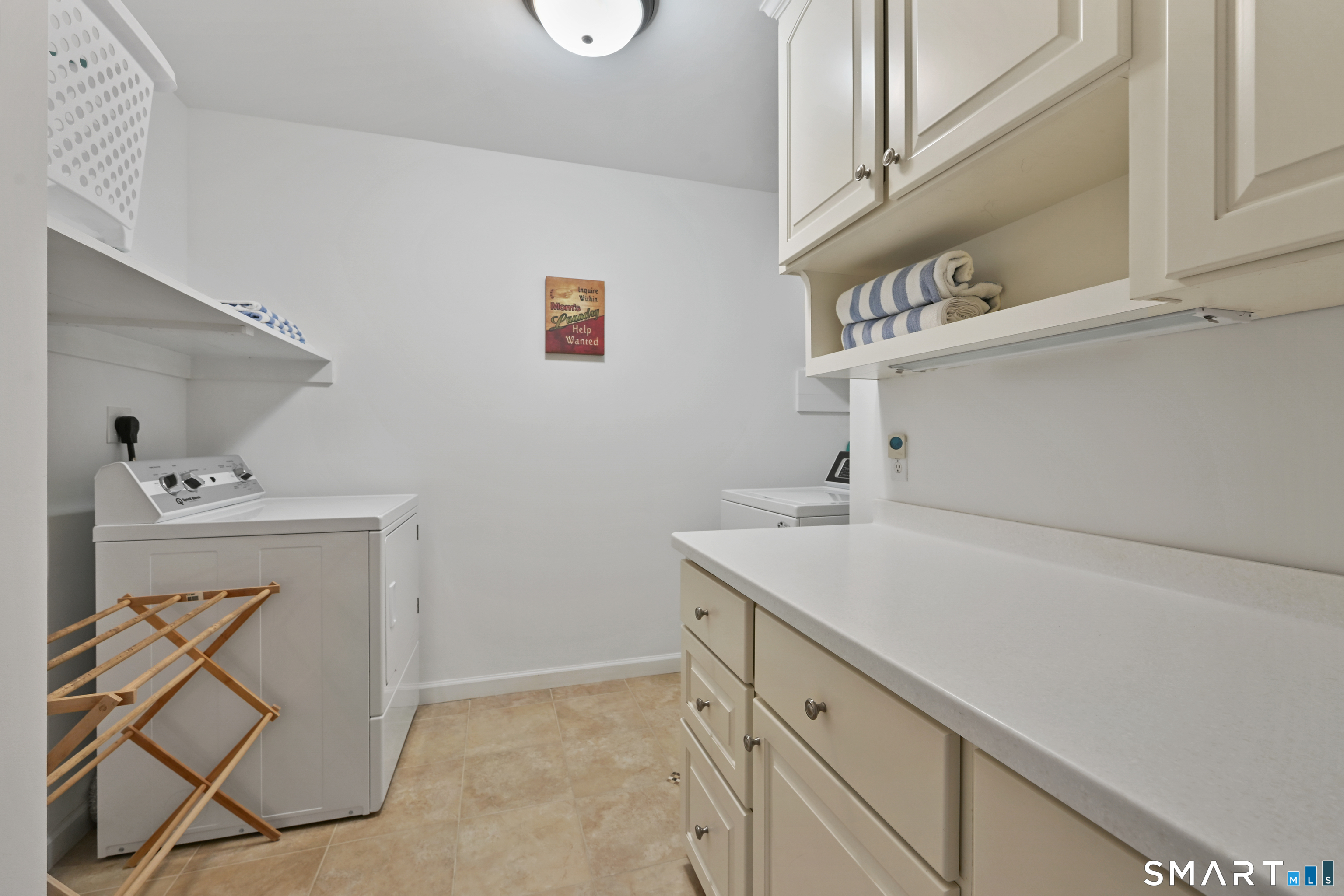 84 Delaware Road Easton, CT 06612 - Photo 24 of 39 a utility room with cabinets washer and dryer