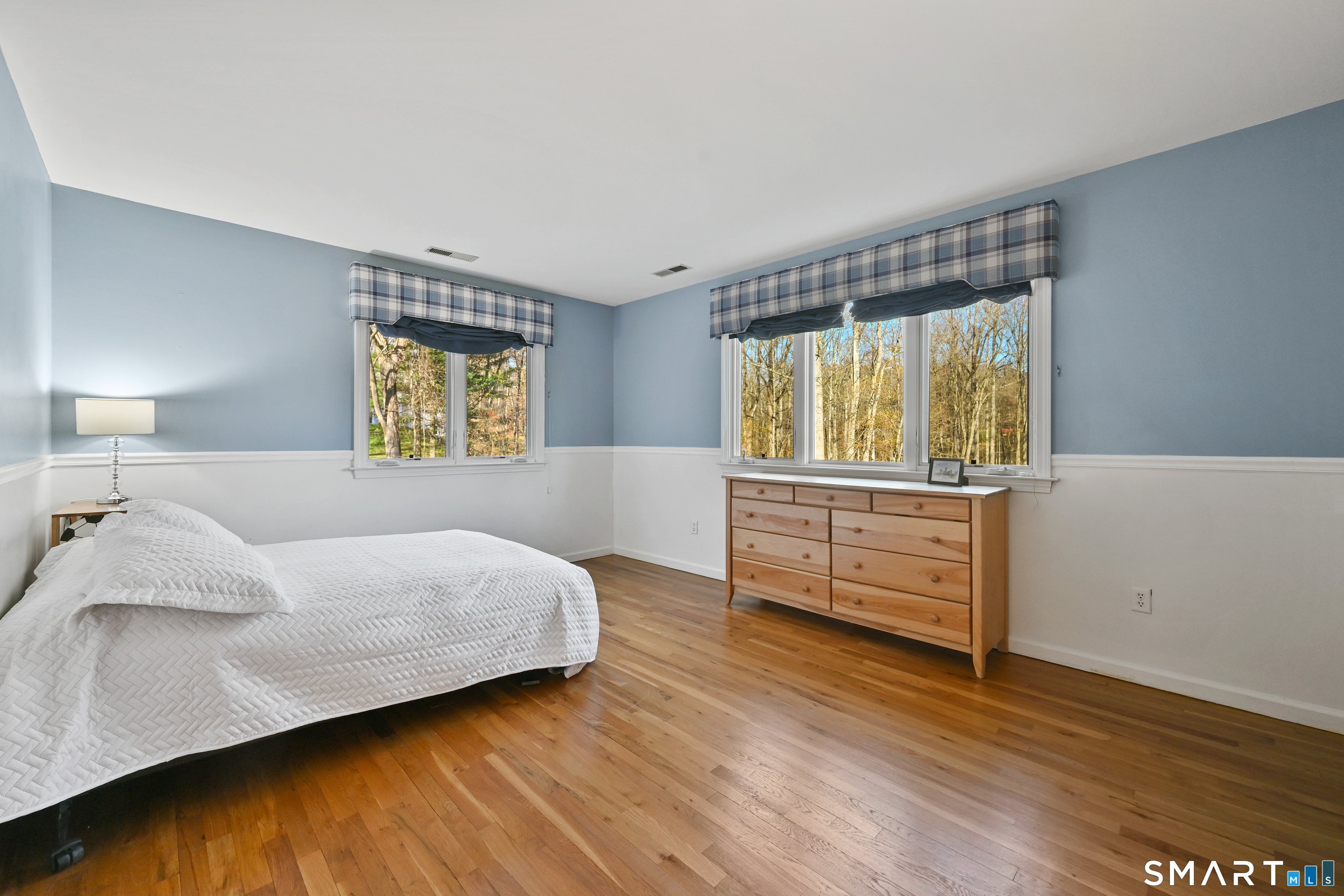 84 Delaware Road Easton, CT 06612 - Photo 25 of 39 a bedroom with a bed and wooden floor