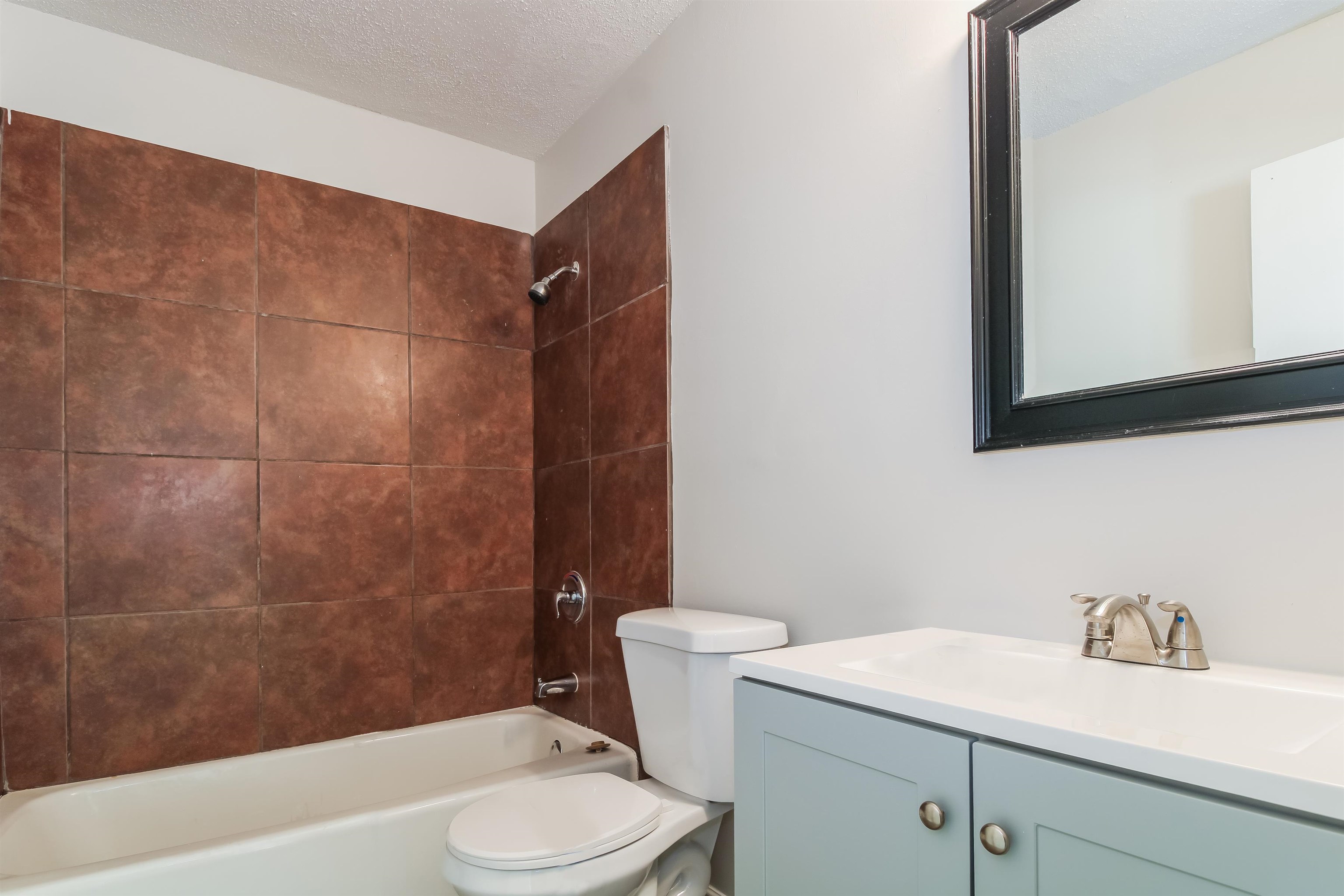 4014 Stowe Street Memphis, TN 38128 - Photo 13 of 16 a bathroom with a sink a toilet and shower