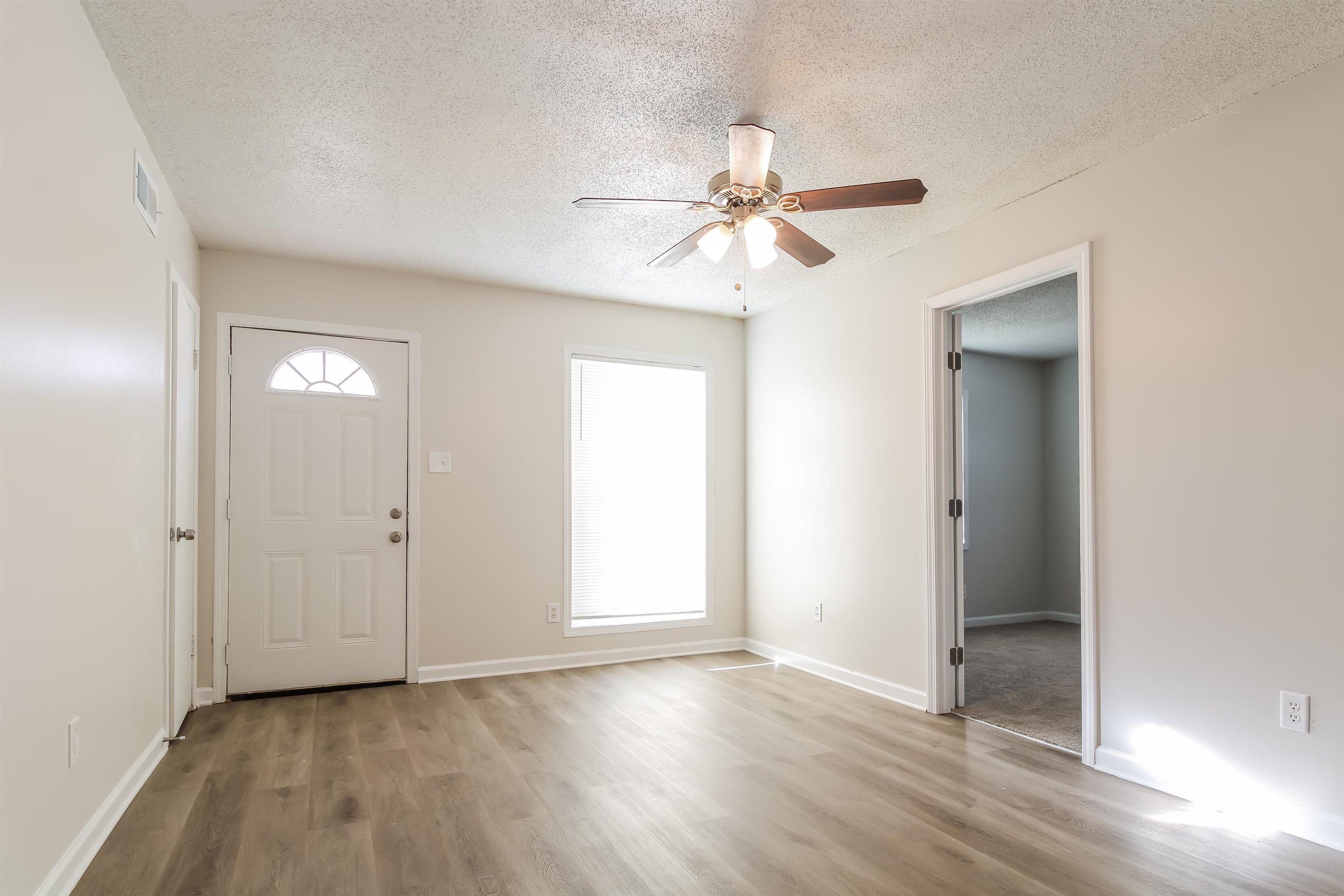 4014 Stowe Street Memphis, TN 38128 - Photo 4 of 16 a view of an empty room with wooden floor