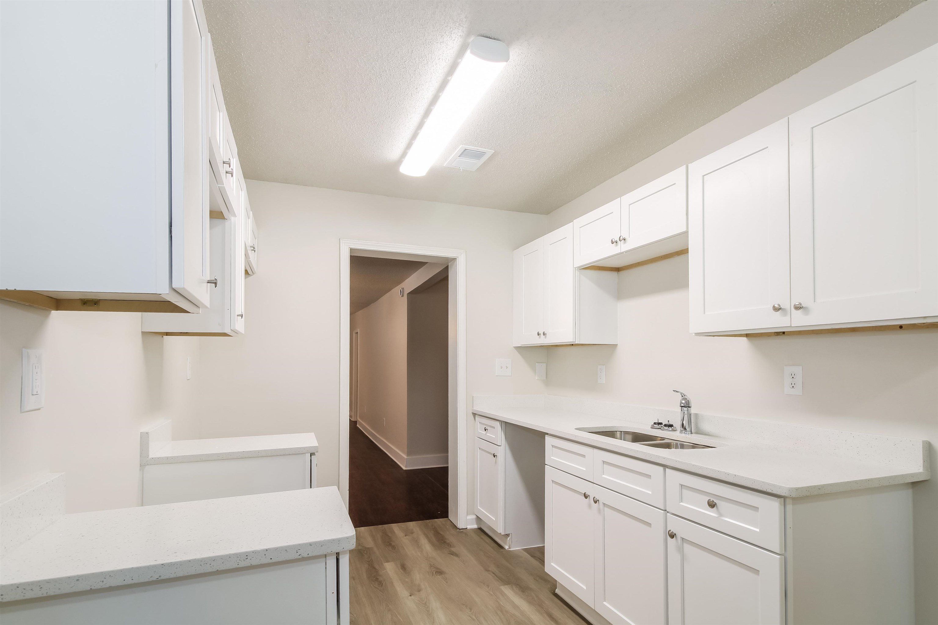 4014 Stowe Street Memphis, TN 38128 - Photo 6 of 16 a kitchen with granite countertop white cabinets and white appliances
