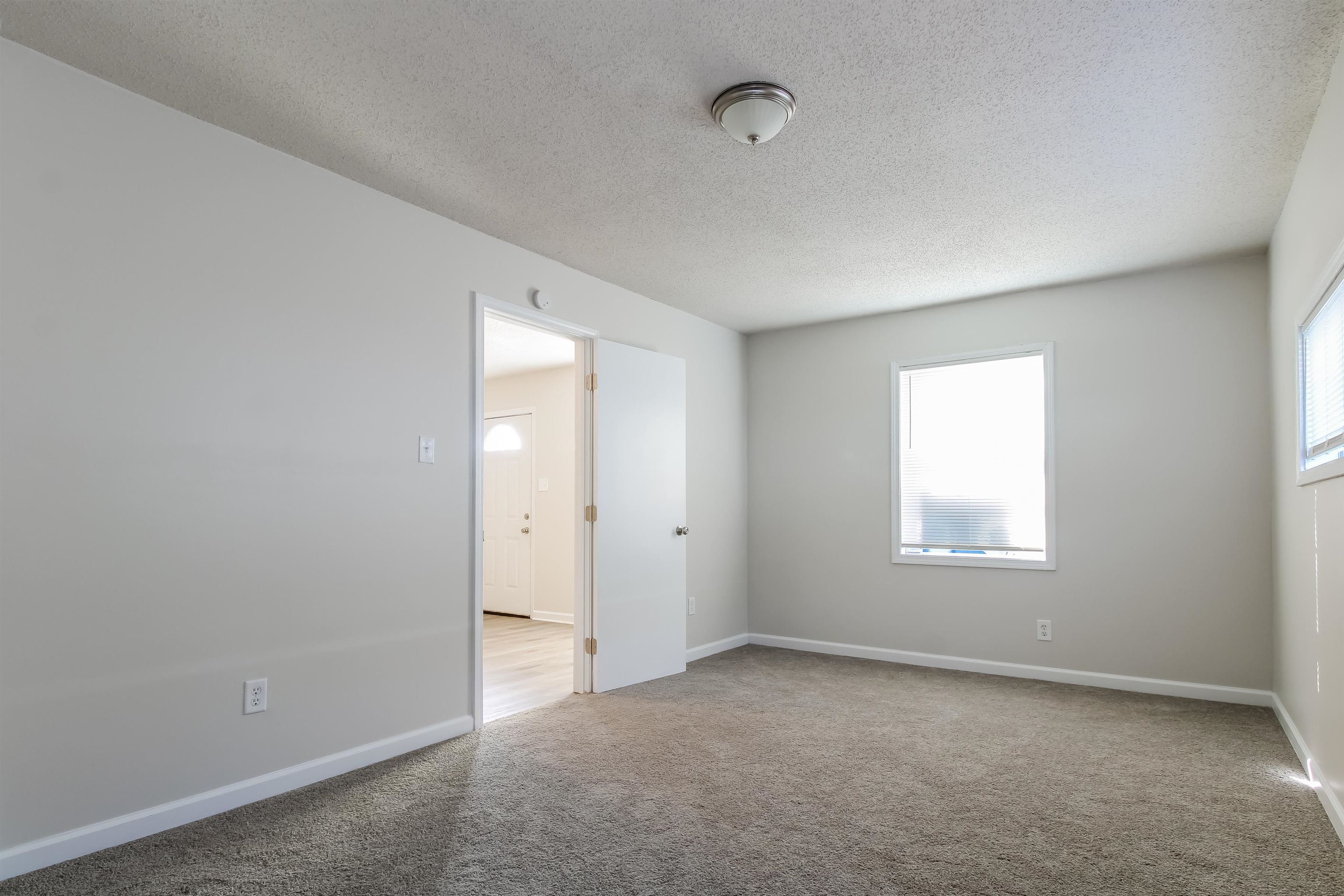 4014 Stowe Street Memphis, TN 38128 - Photo 7 of 16 an empty room with windows and closet