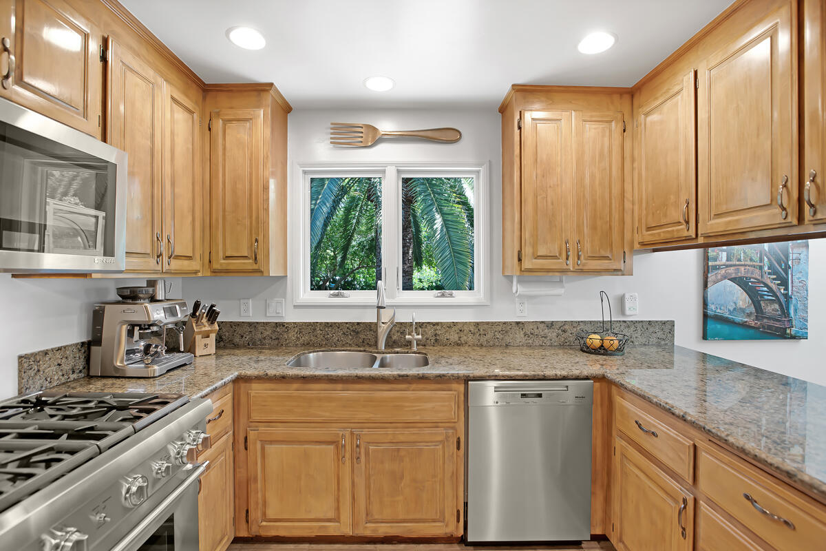 4009 Primavera Road Santa Barbara, CA 93110 - Photo 12 of 41 a kitchen with stainless steel appliances granite countertop a sink stove and cabinets