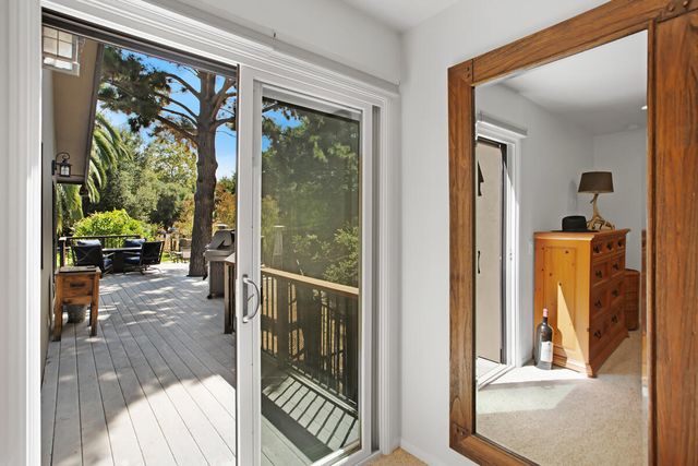 a view of a hallway with wooden floor and a livingroom view