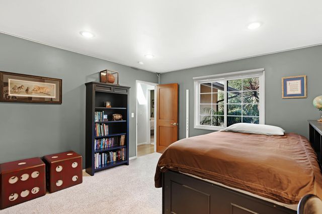 a bedroom with a bed dresser and a window