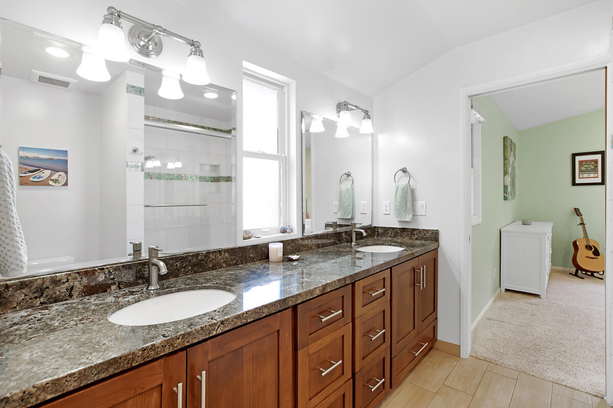 4009 Primavera Road Santa Barbara, CA 93110 - Photo 28 of 41 a bathroom with a granite countertop double vanity sink and mirror