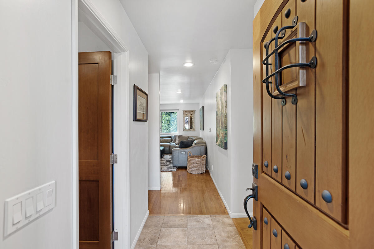 4009 Primavera Road Santa Barbara, CA 93110 - Photo 7 of 41 a view of a hallway with wooden floor and windows