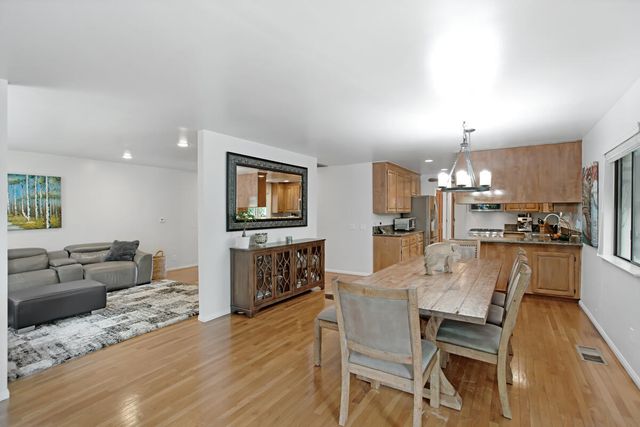 a dining room with furniture and wooden floor