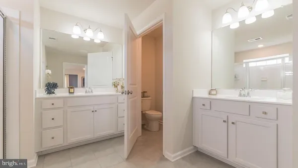 a bathroom with a double vanity sink and a mirror
