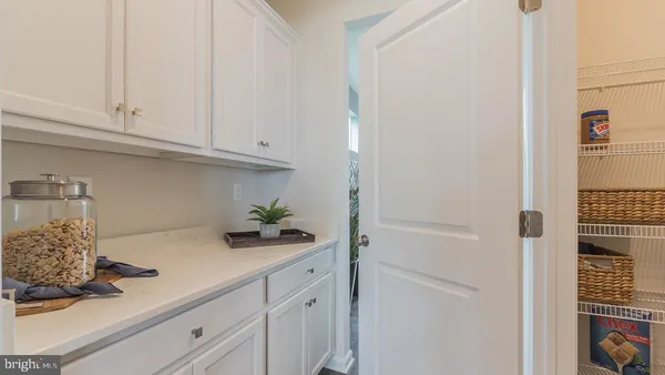 a kitchen with white cabinets and a sink