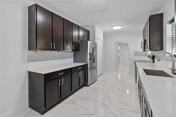 a kitchen with stainless steel appliances a sink stove and cabinets