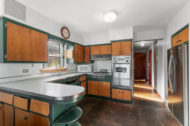 a kitchen with stainless steel appliances granite countertop a sink stove and refrigerator