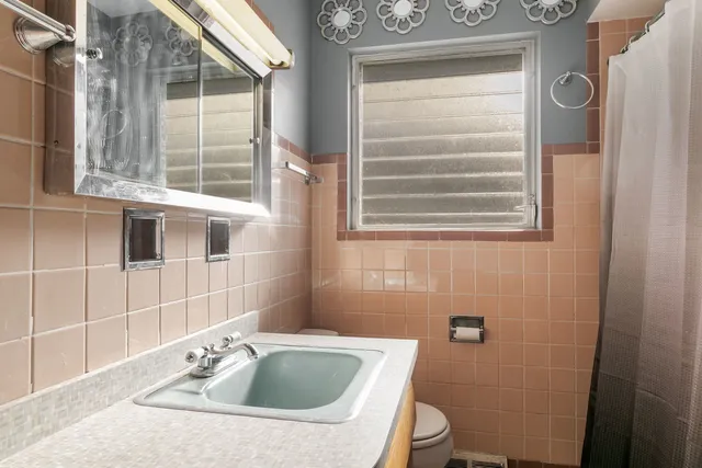 a bathroom with a sink and a window