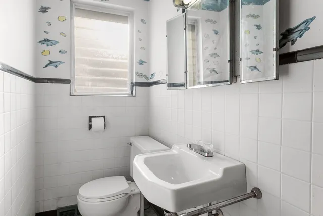 a bathroom with a sink a toilet and a mirror