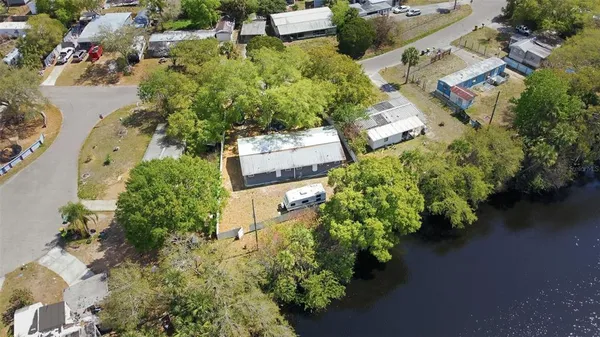 an aerial view of a house with a yard basket ball court and outdoor seating