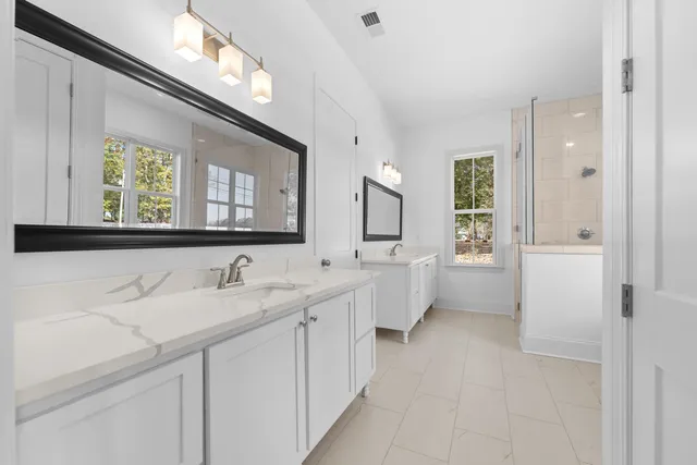 a view of a room with wooden floor and a ceiling fan