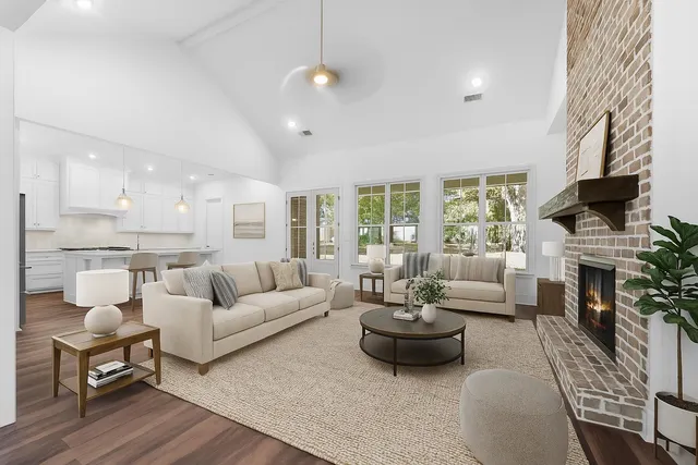 a living room with furniture fireplace and a large window