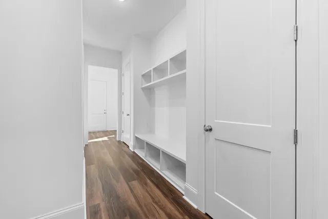 a view of a hallway with wooden floor