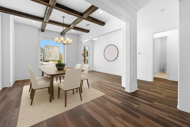 a dining room with wooden floor a glass table and chairs