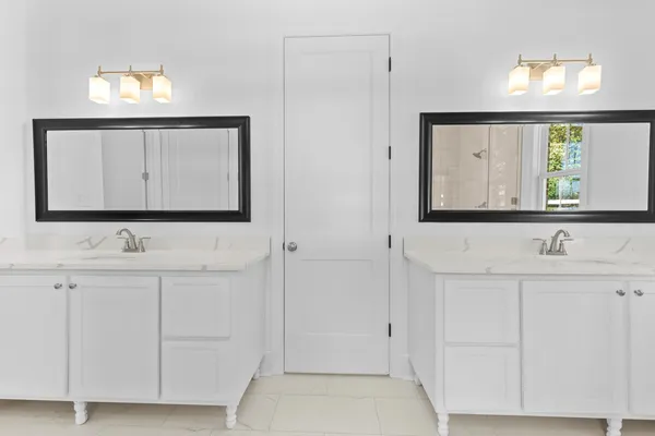 a bathroom with a granite countertop sink a toilet and a mirror