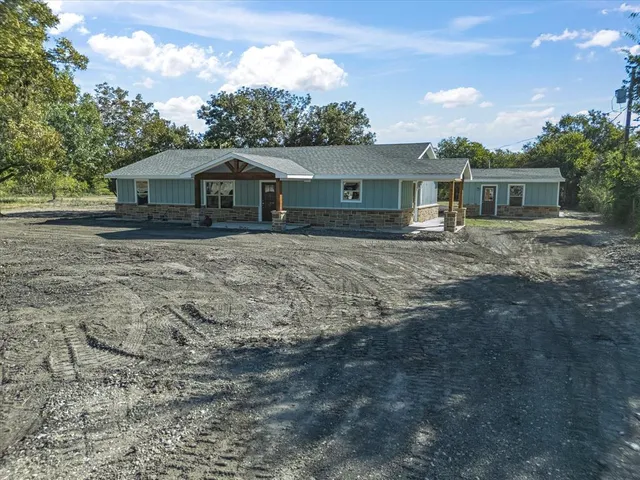 a front view of a house with yard