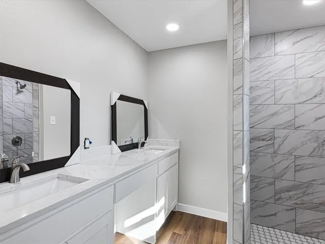 a bathroom with a double vanity sink and a mirror