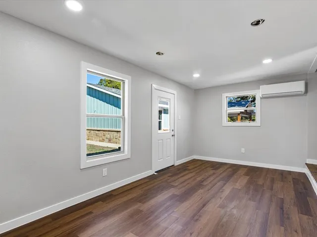 a view of a room with wooden floor and window