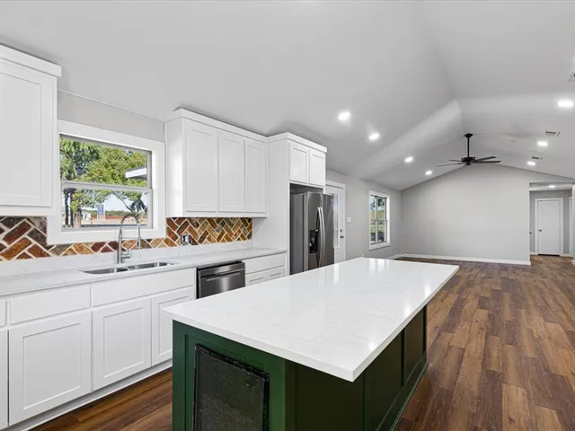 a kitchen with a stove a refrigerator and a sink