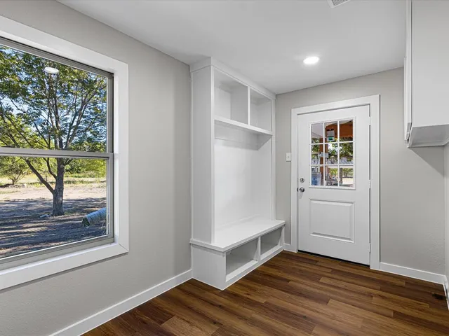 an empty room with windows and closet