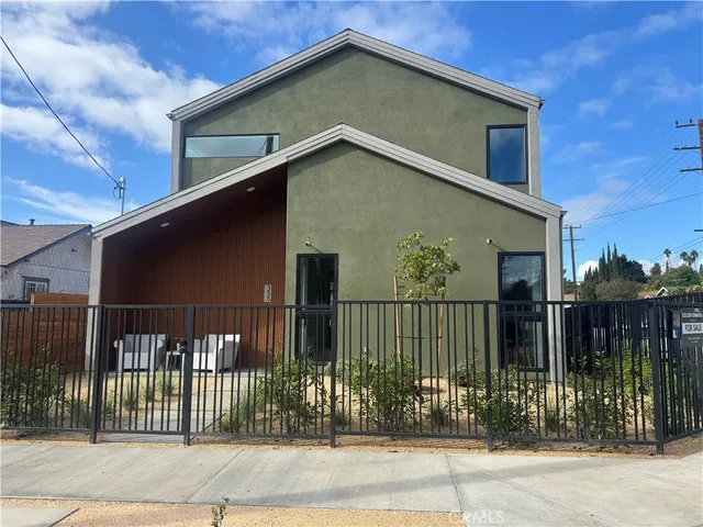 a view of a house with wooden fence