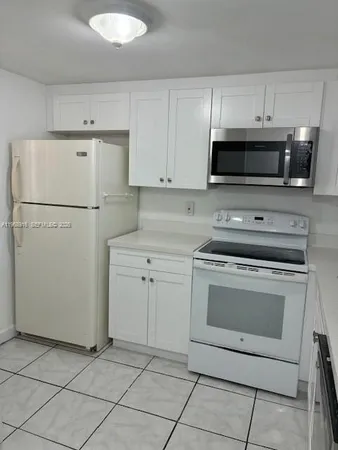 a kitchen with cabinets stainless steel appliances and a counter space