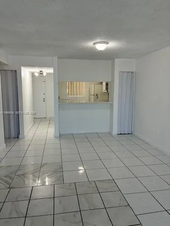 a view of a livingroom with an empty space and a window